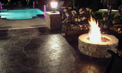 Stamped patio and pool surround with fire pit done by Grand Rapids Stamped Concrete.
