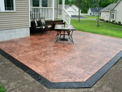 Residential stamped patio with a dark brown border.