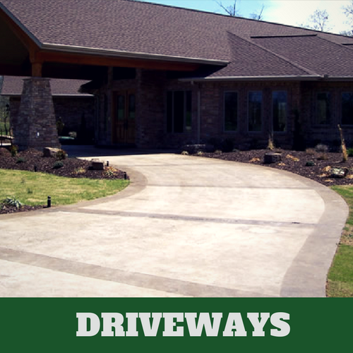 Two toned colored concrete driveway in Grand Rapids, Michigan with brick home.