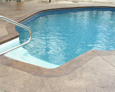 Brown stamped concrete pool deck.