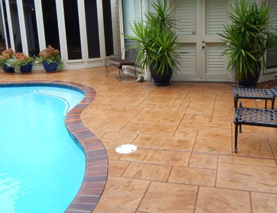 Stone shaped stamped concrete pool deck.
